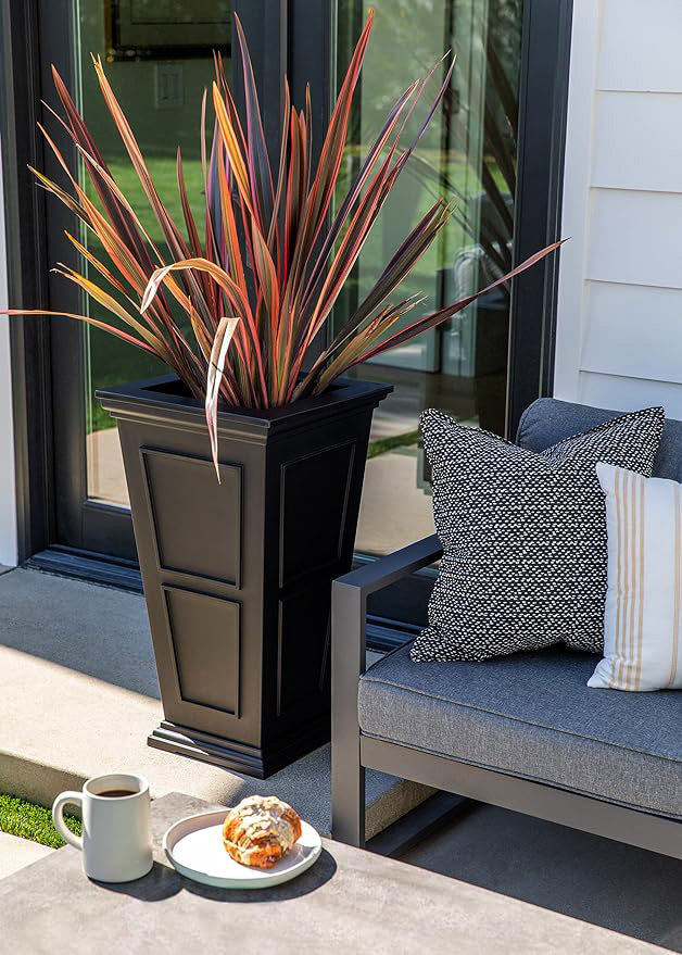 A black planter with a coffee cup and a plate of cookies, adding warmth and coziness to the room.