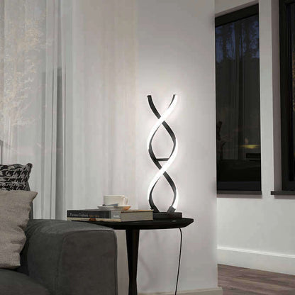 An elegant, helix-shaped floor lamp stands beside a sofa, casting a soft light on a modern living room corner with a side table and books.